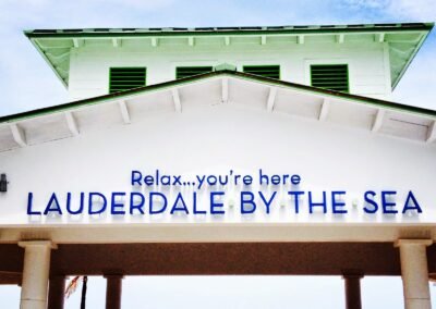 Sign at the pier saying "Relax...you're here - LAUDERDALE BY THE SEA"