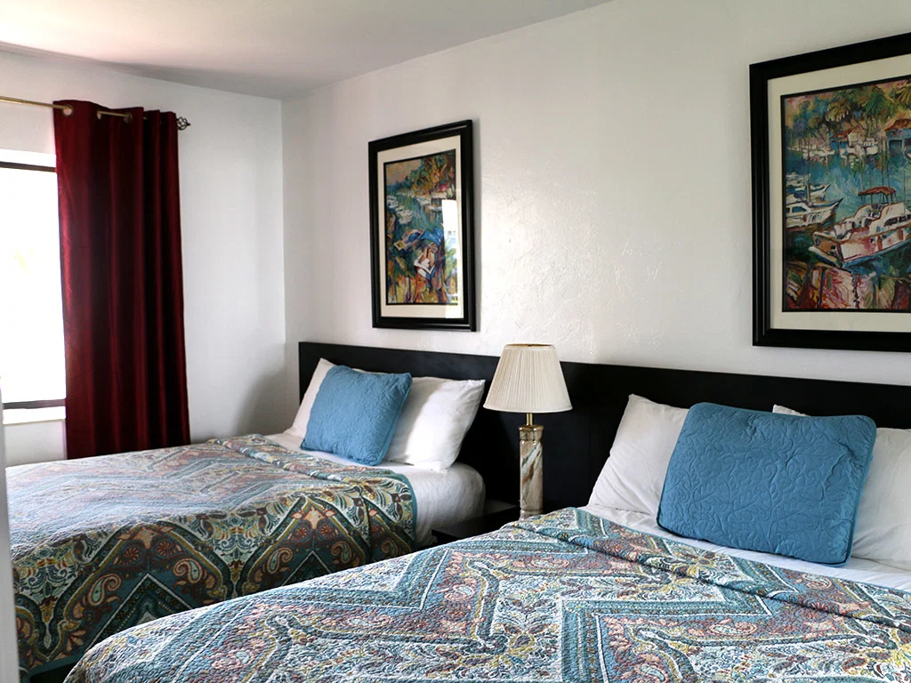 Breakaway Inn bedroom Photo displaying two full size beds and headboards.